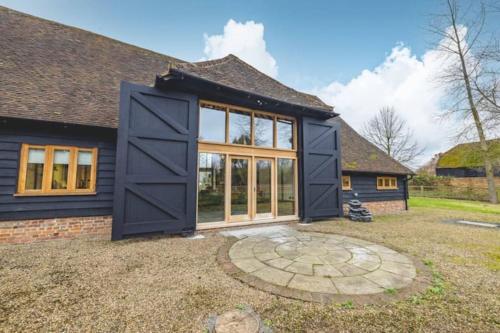 an extension to a house with a large door at Dorney,Windsor Family Getaway with Hot Tub in Buckinghamshire