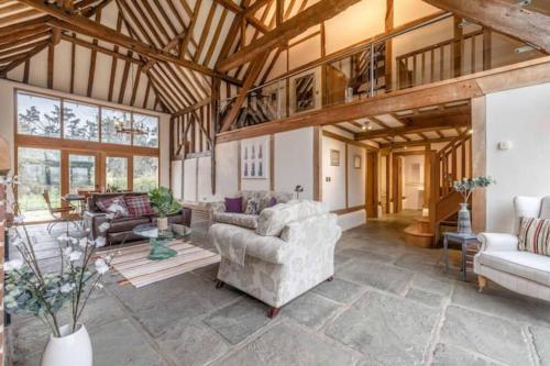 a living room with couches and chairs in a building at Dorney,Windsor Family Getaway with Hot Tub in Buckinghamshire