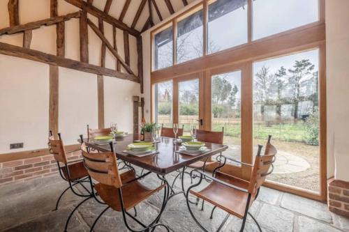 a dining room with a wooden table and chairs at Family Friendly Retreat Dorney,Windsor in Buckinghamshire