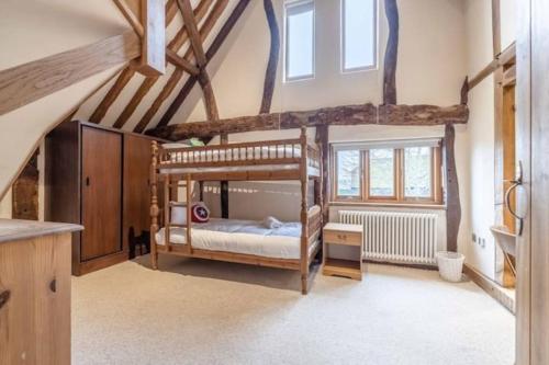 a bedroom with two bunk beds in a attic at Family Friendly Retreat Dorney,Windsor in Buckinghamshire