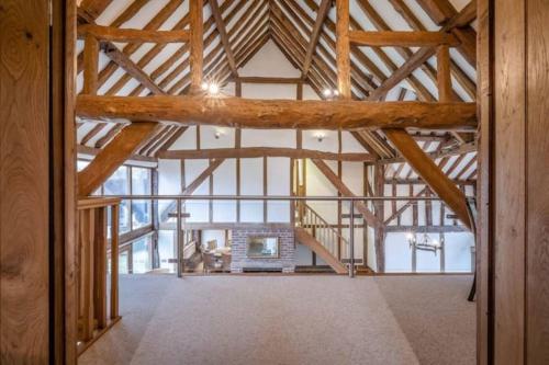 an open room with a large wooden ceiling with beams at Dorney,Windsor Family Getaway with Hot Tub in Buckinghamshire