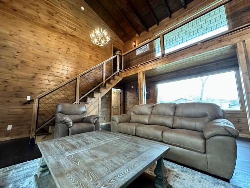 a living room with a couch and a table at Creekfront Lodge: Brand new! in Pigeon Forge