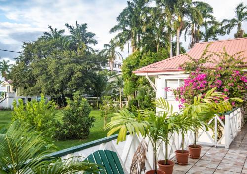a view of a garden from a balcony with plants at Harbour View Boutique Hotel & Wellness Retreat in Belize City