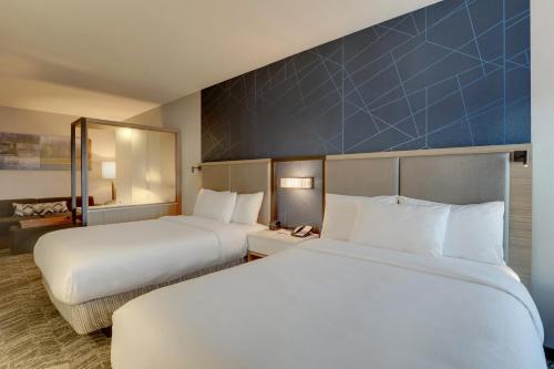 a hotel room with two beds and a blue wall at SpringHill Suites by Marriott Cheraw in Cheraw