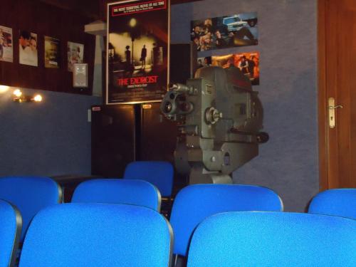 a room with blue chairs and a machine in the middle at Casona El Gurugu in Luarca