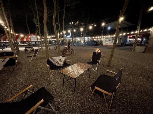 a group of chairs and a table at night at Qilin Valley in Puli