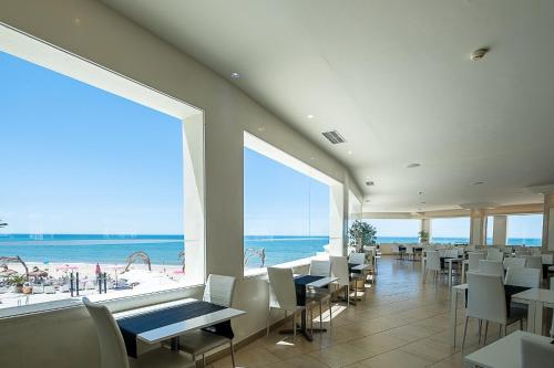 a restaurant with a view of the beach at ON Hotels Oceanfront Adults Designed in Matalascañas