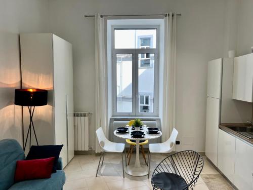 a living room with a table and a window at Duomo Inn Apartments in Naples