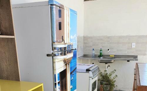 a kitchen with a sink and a refrigerator at Terraço Ribeira Casa p Temporada in Salvador