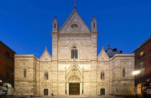 a large building with a clock on the front of it at Duomo Inn Apartments in Naples