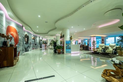 a lobby of a store with furniture and paintings on the walls at ON Hotels Oceanfront Adults Designed in Matalascañas