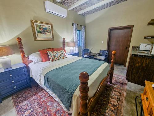 a bedroom with a bed and a table and a chair at La Quinta en Alamos in Álamos