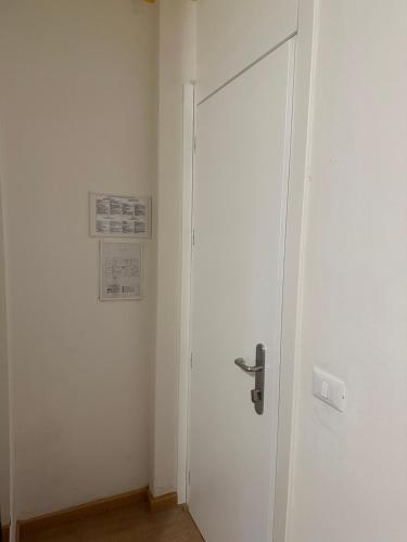 a door in a room with a white wall at Hotel Irene in Lignano Sabbiadoro