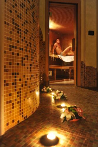 a bathroom with a man in a bath room with lights at Best Western Hotel Dei Cavalieri in Barletta