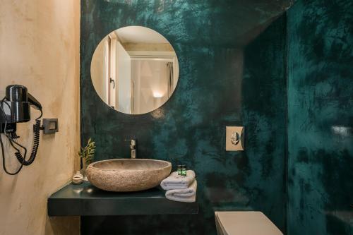 a bathroom with a sink and a mirror at FRG Villas - Villa Volare in Kefallonia