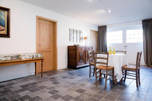 a dining room with a table and chairs at Loweide Lodges & Holiday Homes near Bruges in Oostkamp