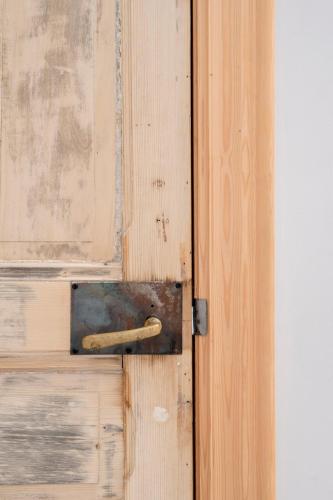 a wooden door with a metal latch on it at Loweide Lodges & Holiday Homes near Bruges in Oostkamp