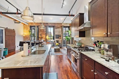 a kitchen with wooden cabinets and a large counter top at Luxurious Condo, Amazing Location in Philadelphia