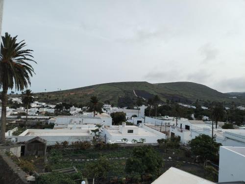 a view of a town with a mountain in the background at Casa Isidro in Haría