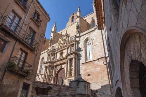 an old stone building with a tower on a street at Casa Maro Prenafeta in Prenafeta
