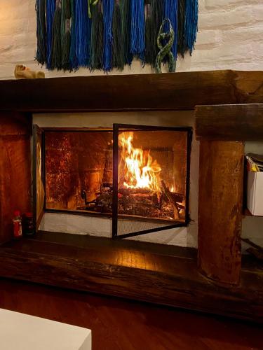 a fireplace with a fire in it at Casa Magnolia in Cumbayá