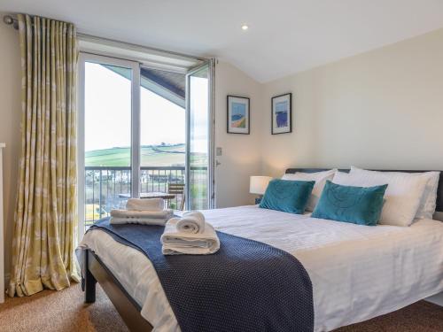 a bedroom with a bed with a large window at 10 Oceans Edge in Kingsbridge