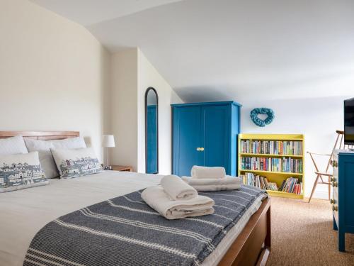 a bedroom with a large bed with towels on it at 10 Oceans Edge in Kingsbridge