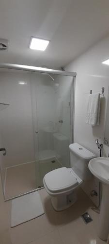 a bathroom with a shower and a toilet and a sink at Pousada Kit Residence in Brasilia