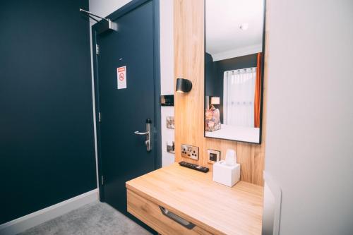 a bathroom with a wooden vanity and a mirror at Thomas Moore Inn in Dublin