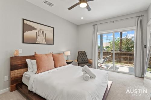 a bedroom with a bed and a large window at Enjoy DT Newly Renovated & Patio and Free Swim Club by Austin Vacay in Austin
