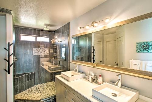 a bathroom with two sinks and a large mirror at Modern Phoenix Haven with Private Pool and Patio! in Phoenix