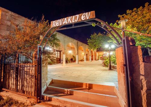 a gate with a street sign in front of a building at Revaklı Ev Guest House in Rizokarpaso