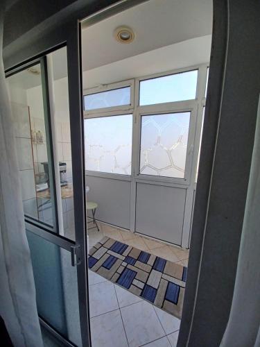 an open door to a bathroom with a window at Apartament la dudu in Sulina