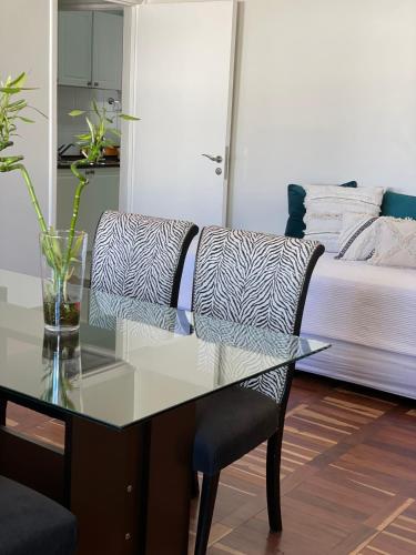 a bedroom with a glass table and a bed at Victoria Plaza in Santiago del Estero