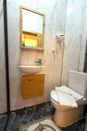 a bathroom with a sink and a toilet and a mirror at The Little Prince Boutique Otel in Antalya