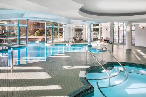 a pool in a hotel with blue water at Delta Hotels by Marriott Grand Okanagan Resort in Kelowna