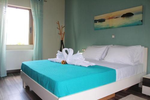 a bedroom with a bed with a towel on it at Kallia's Modern Apartment in Kissamos