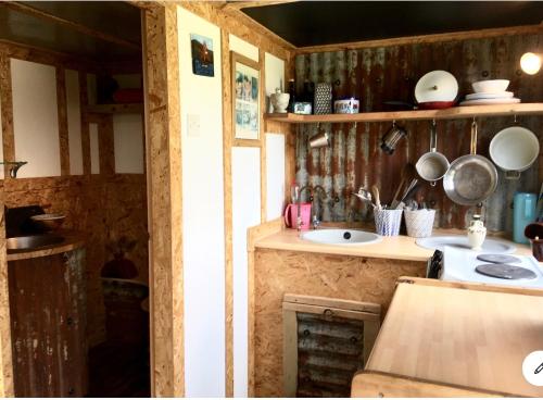 a small kitchen with a sink and a counter at Field Hut in Wadebridge