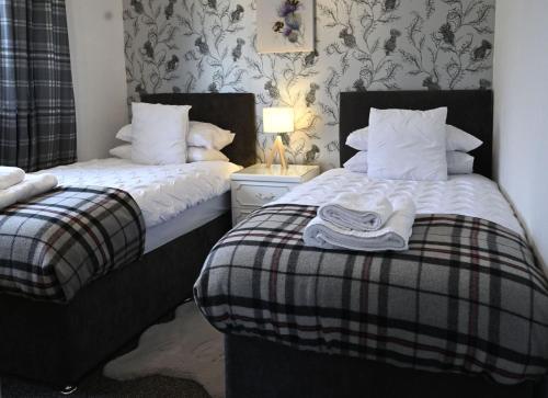 two beds sitting next to each other in a bedroom at Sealladh Mairi in Fort William