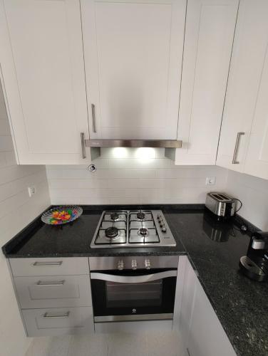 a kitchen with a stove and a plate on the counter at Casa Veríssimo in Porto