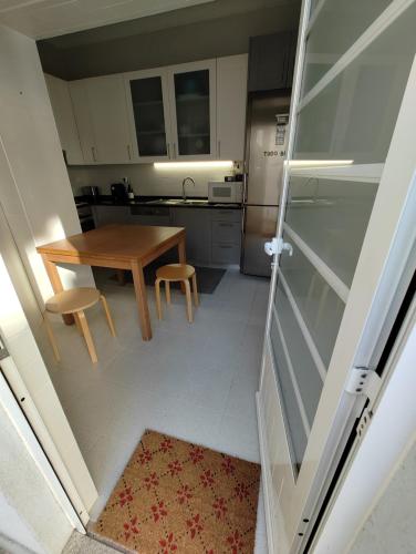 a small kitchen with a wooden table and chairs at Casa Veríssimo in Porto