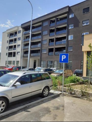 a silver car parked in front of a parking lot at Apartman kod Brke 20 A Bulevar Vojvode Živojina Mišiča in Banja Luka