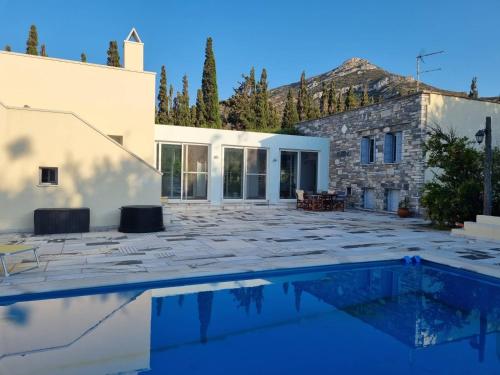 a villa with a swimming pool and a building at Margouno Eco-Villa, Eggares, Naxos in Eggares