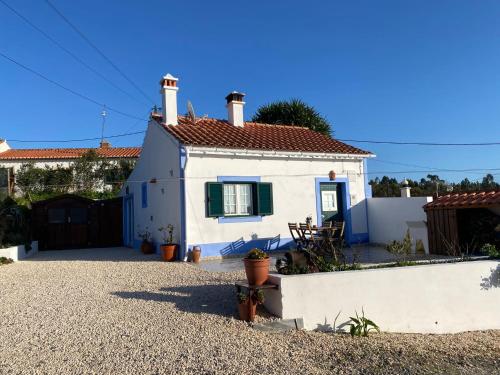 a white house with a red roof at Casa do Brejão campo e praia in Odemira
