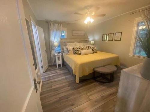a bedroom with a bed with a yellow bedspread at Luxurious and peaceful in Topeka