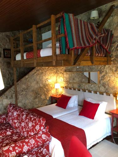 a bedroom with two beds and a couch at Casas Dos Infantes - Turismo Rural in Caldas da Rainha
