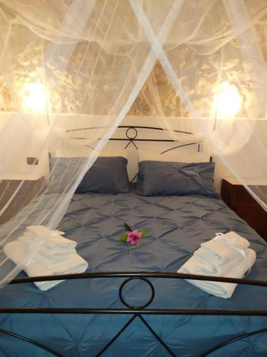 a bed in a tent with a flower on it at Casetta degli Etruschi in Allumiere
