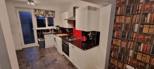 a kitchen with a book shelf filled with books at 1 bedroom Sculcoates house Hull in Hull
