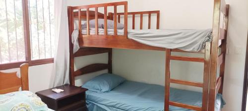 a couple of bunk beds in a room at Flor de Sacuanjoche, Chinandega in Chinandega