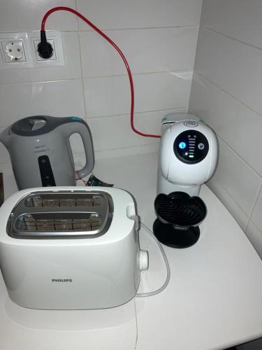 a white toaster sitting on top of a counter at FOZ II PLAYAS in Foz